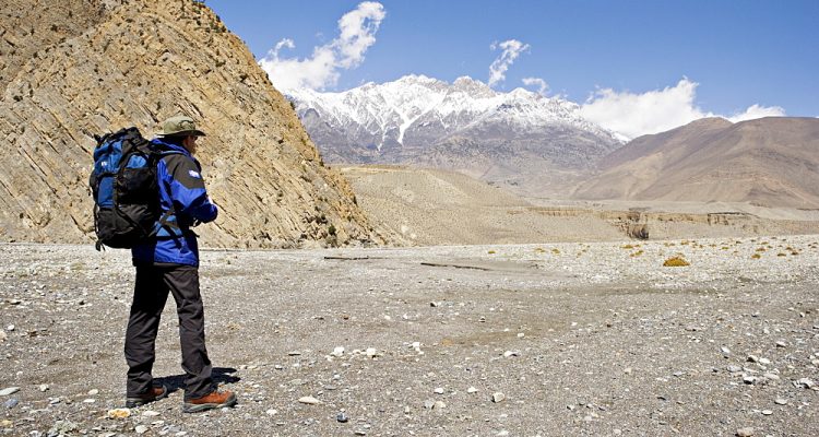 Trekker enjoys the view on the Annapurna circuit trek, between Jomsom and Muktinath, Himalayas, Nepal, Asia