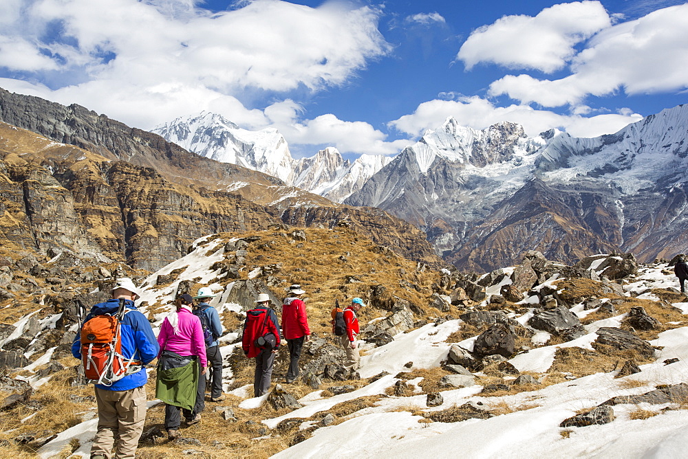Trekkers at Annapurna Base Camp at 4130 metres looking towards Machapuchare, Annapurna Sanctuary, Himalayas, Nepal, Asia